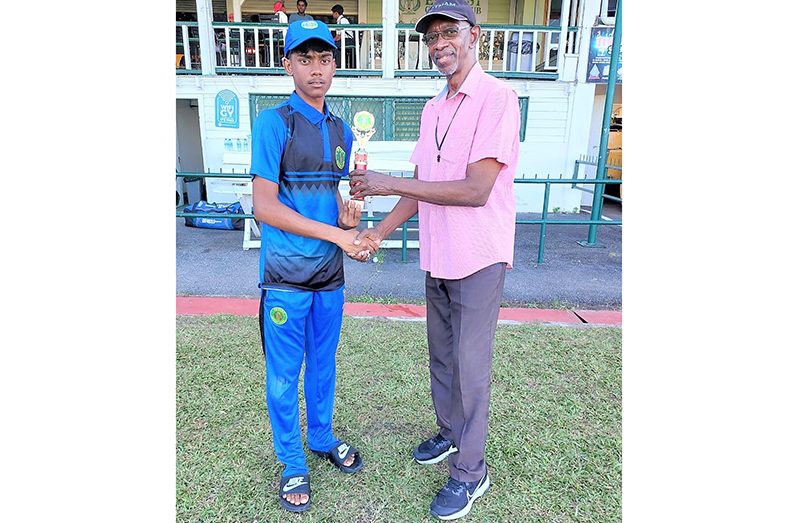 Devon Wilkinson (left) receives the MOM trophy from Match Referee Grantley Culbard
