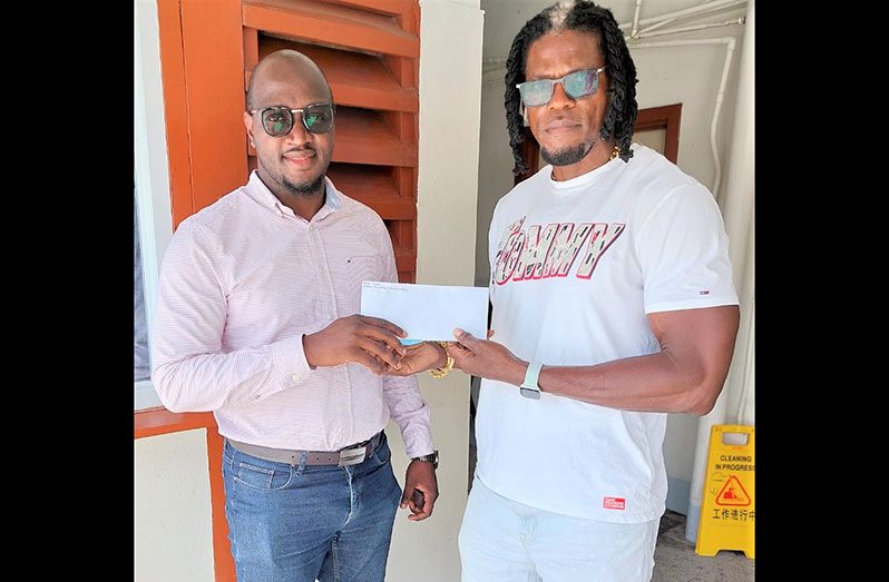 Tournament organiser, Rawle Toney at (left) and Dexter Garnett of Bushman Pawnshop and Money Lending enterprise during a presentation.