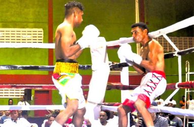 (flashback) Elton Dharry (left) backs up Romos Roland on the ropes but could not find the KO punch (Sean Devers photo)