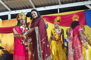 President of the Guyana Hindu Dharmic, Sabha Dr. Vindhya Persaud handing over a prize to a young female