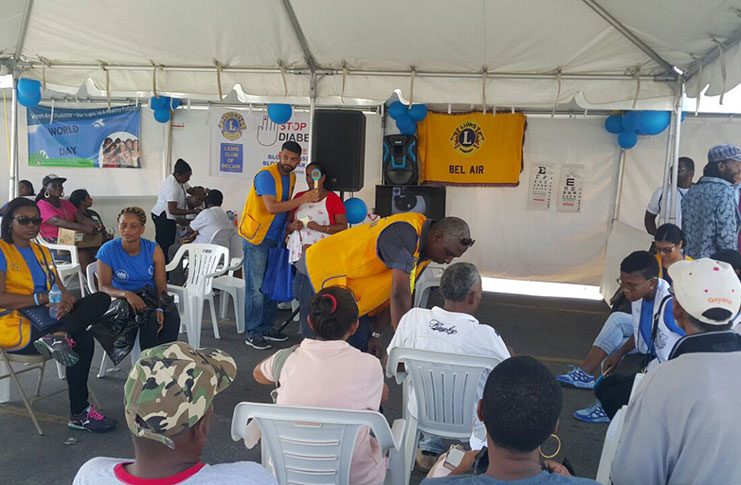 Members of the Lions of Bel-Air attending to persons during the outreach at Stabroek Market Square
