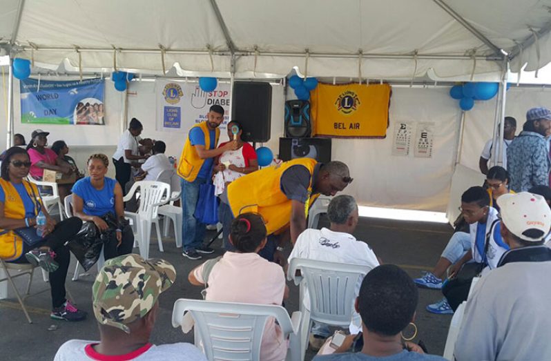 Members of the Lions of Bel-Air attending to persons during the outreach at Stabroek Market Square