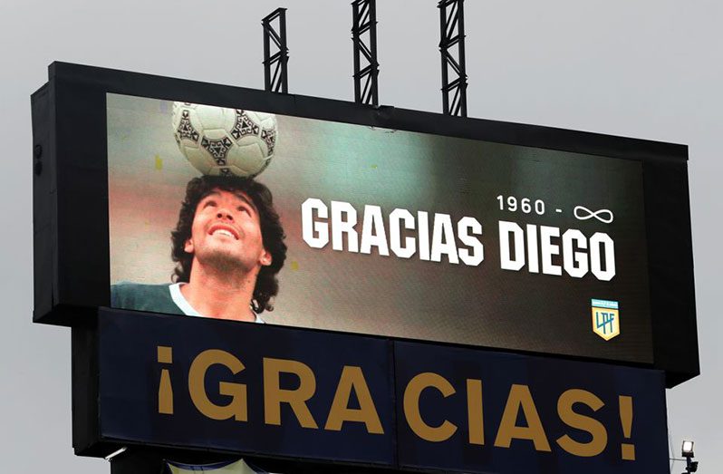 Diego Maradona – Boca Juniors v Newell’s Old Boys – Estadio La Bombonera, Buenos Aires, Argentina – November 29, 2020. A screen displays an image of Diego Maradona and the legend “1960-infinity Thanks Diego” as a tribute (Pool via REUTERS/Alejandro Pagni)