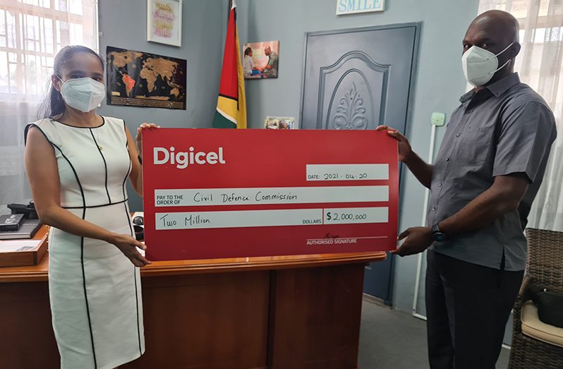 Digicel’s Head of Commercial, Simone Pierre, hands over a ceremonial cheque to Director-General of the CDC, Lieutenant Colonel Kester Craig, on Monday at the CDC’s head office, Thomas Lands