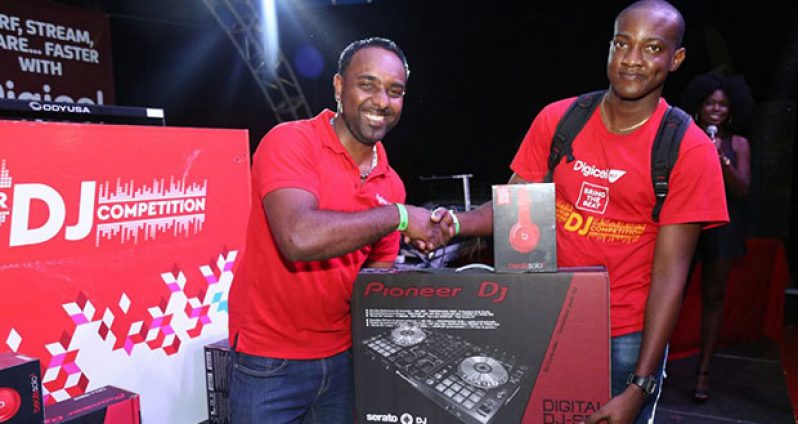 Digicel Marketing Manager Ramesh Rupchand presents one of the prizes to winner of the competition, Selector Keston