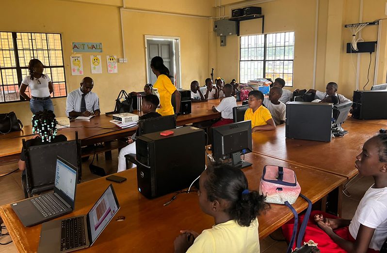 Some of the Mahaicony Stem Club members during their first robotics class using their new laptops from Digicel.