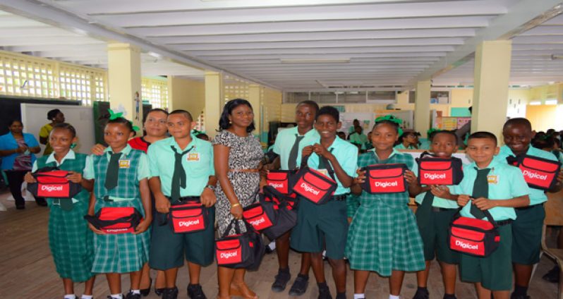 Students of Kingston Secondary posing with their back-to-school bags on Monday, compliments of Digicel