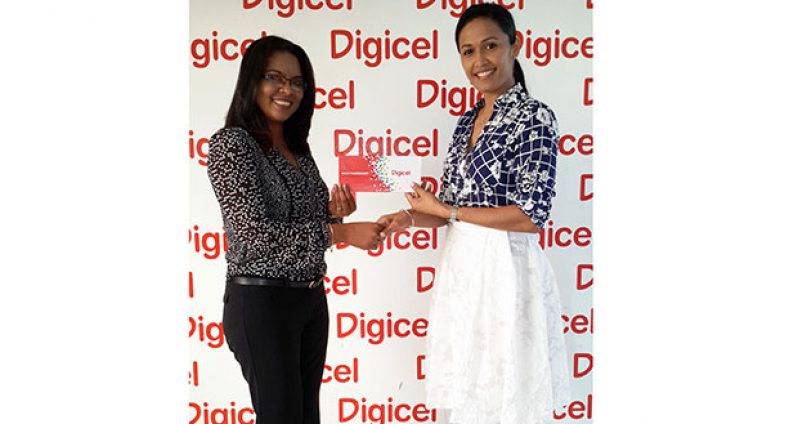 Digicel's Public Relations Officer, Vidya Bijlall-Sanichara, hands over a cheque to Marcelle Shewjattan, Secretary of the QCPTA