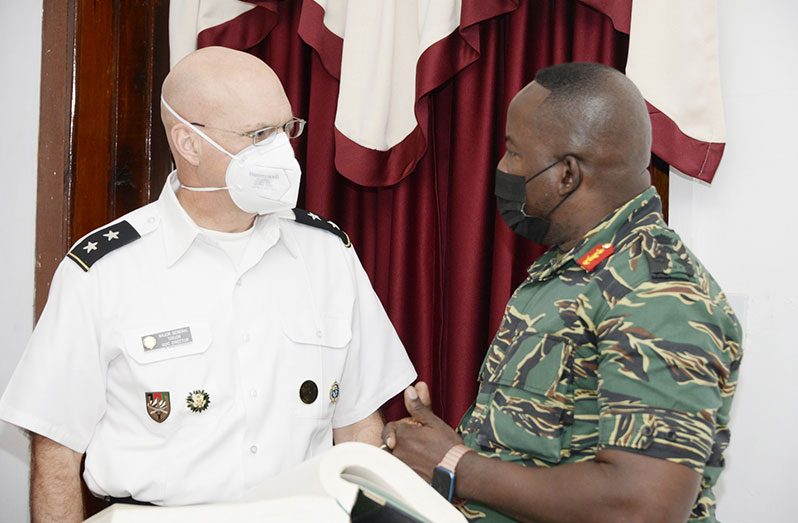 IACD Director, Major General James Taylor and Chief-of-Staff Brigadier Godfrey Bess in discussion at the Officers' Club, Base Camp Ayanganna