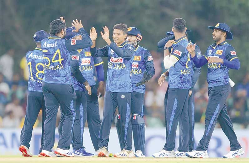 Dunith Wellalage is congratulated by his team-mates for dismissing Roston Chase•Oct 15, 2024•Associated Press