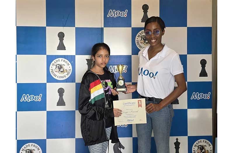 Divya Persaud receives her Championship trophy from Ms. Aaliyah Kendall (R), Brand Manager MOO!