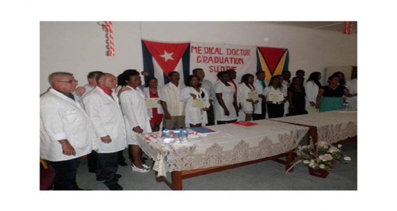 Graduates with Cuban Director Dr. Midlis Otero Fernandez and other Cuban doctors in the Suddie Hospital boardroom for the graduation ceremony last Thursday