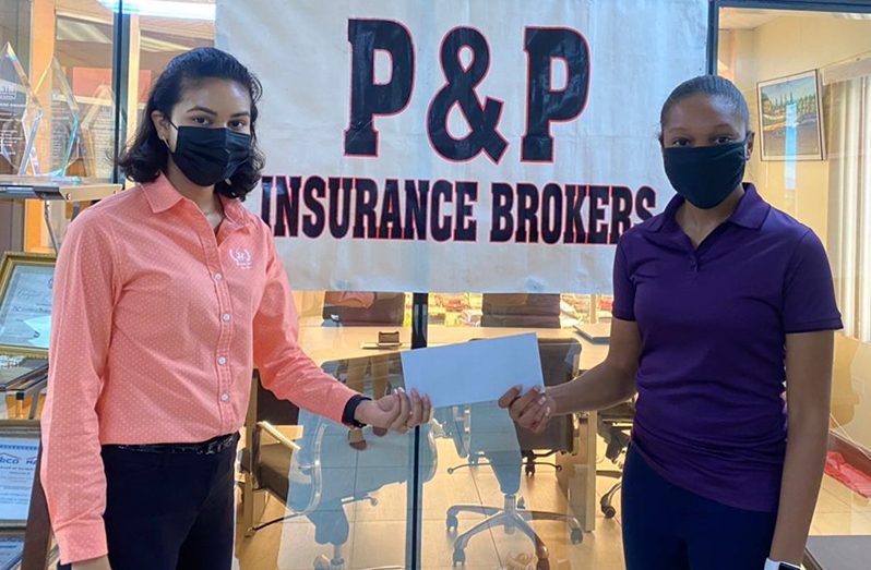 Jaya Panday, (at left) Accounting Executive of P&P Insurance makes the presentation of a cheque for an undisclosed amount to Table Tennis star, Chelsea Edghill.