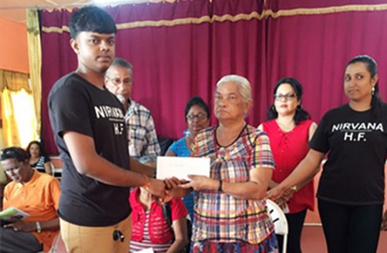Hymwant Deepan (left) flanked by other executive members of Nirvana Humanitarian Society presenting the sum of GYD $80,000 to Ms. Bibi Zulaika Khan (Right) to assist with her medical expenses for a critical heart surgery to be performed in Guyana in February/March 2017