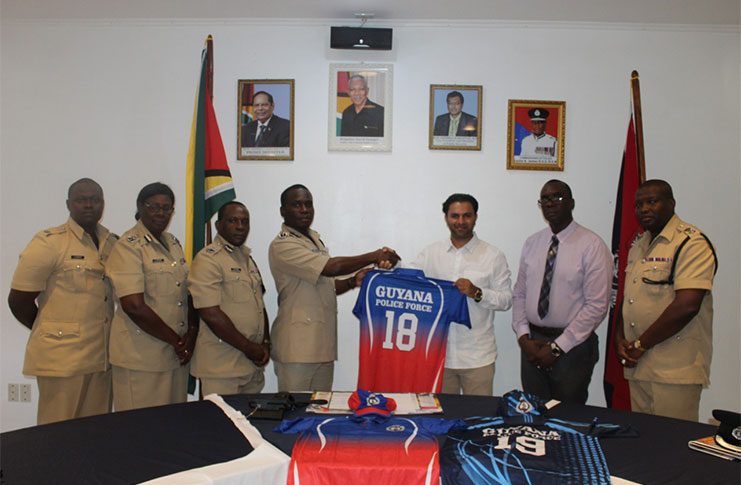 Commissioner of Police Leslie James receives the donation from detective, Sheryar Hussain, of the NYPD for the Force’s cricket team. Also present in photo are the other senior police officers