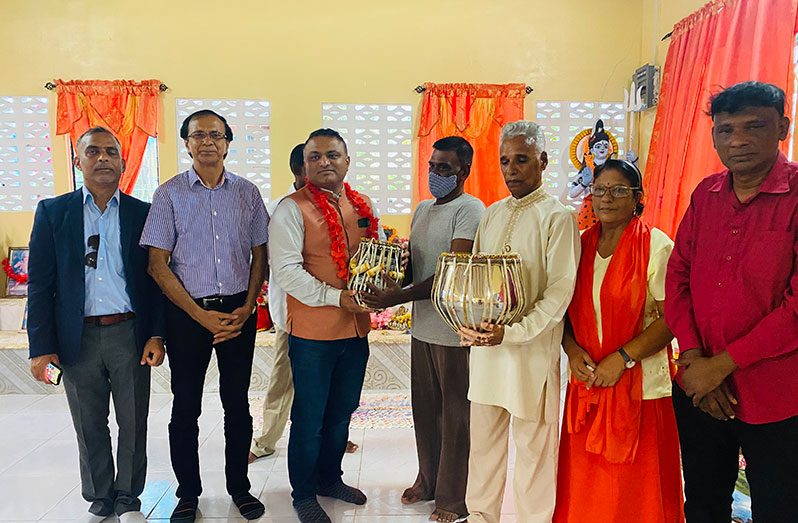 Indian High Commissioner to Guyana, Dr K J Srinivasa, handing over the tabla musical instruments to the members of Richmond Temple, Region Two.