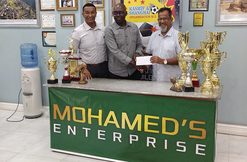 Mohamed’s Enterprise CEO, Nazar Mohamed (right) presents the grand prize cheque to Co-Director of the K&S Organisation, Aubrey "Shanghai" Major in the presence of fellow Co-Director, Kashif Muhammad (left) (Clifton Ross photo)