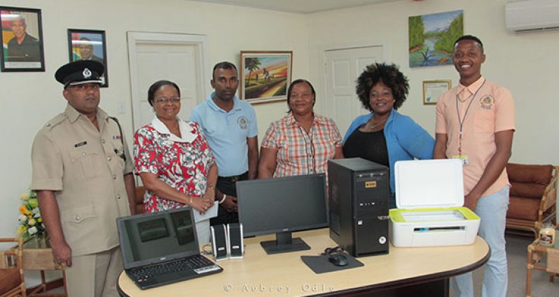 Superintendent of Police Mahendra Singh; Minister of Social Protection Volda Lawrence; Assistant Chief Probation and Social Security Officer, Mahendra Thakurdat; Aileen Chalmens and Elizabeth Williams of the Agricola Group; and Dwayne Brhamdeow of POTS Guyana at the presentation ceremony. (Aubrey Odle photo)