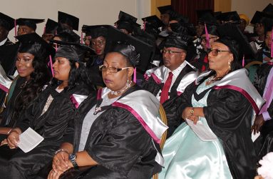 Donna seated among the graduands who would all receive MBAs