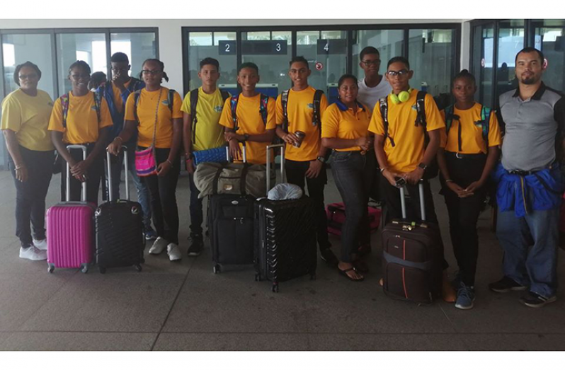 Head coach Nicholas Fraser (right) along with some of the swimmers, prior to leaving Guyana on Tuesday.