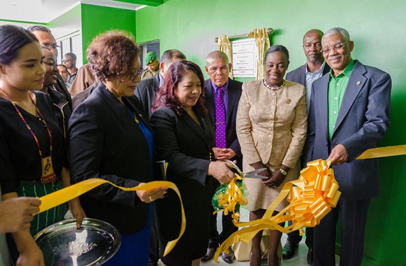 President David Granger and Minister within the Ministry of Indigenous Peoples’ Affairs, Valerie Garrido-Lowe, assisting Minister of State Dawn Hastings-Williams in cutting the ribbon – a symbolic gesture to mark the opening of the Tertiary Students’ Dormitory. Also in photo are Minister of Education, Dr Nicolette Henry; Minister of Social Cohesion, Dr. George Norton; and Vice President and Minister of Indigenous Peoples’ Affairs, Sydney Allicock among other officials.