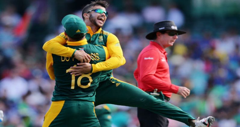 JP Duminy, who is being hugged by Faf du Plessis, bowled a double-wicket maiden to jolt Sri Lanka’s batting in yesterday’s ICC World Cup quarter-final encounter.