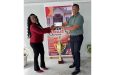 General Manager of Hercules Construction Services, Ms. Okeisha Douglas hands over the sponsorship cheque to Kashif and Shanghai Co-Director, Kashif Muhammad
