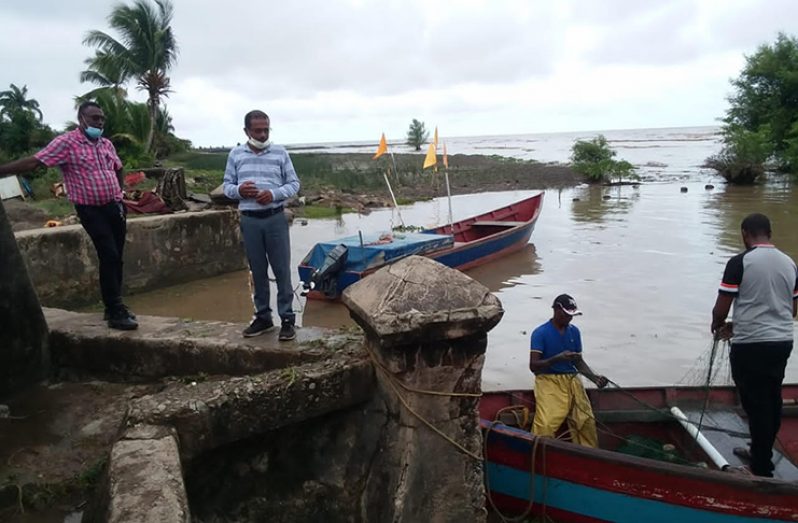 Regional Vice-Chairman Humace Odit (second left) inspects a sluice at Affiance