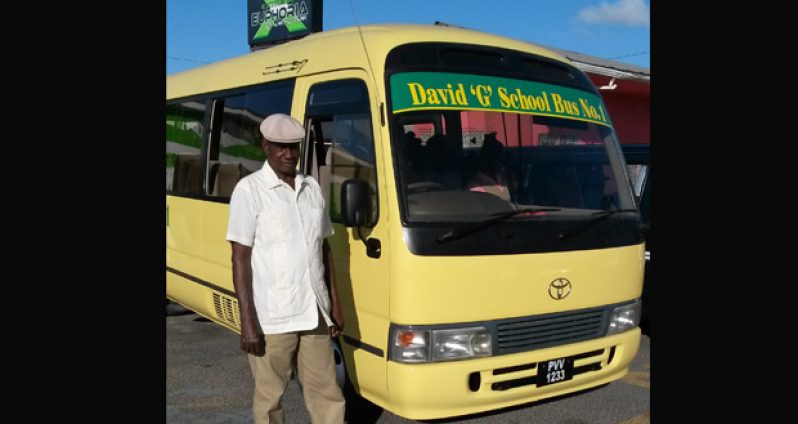In good hands: Veteran bus driver Egbert McPherson awaiting children for the home run
aboard