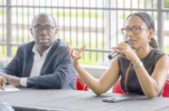 Minister of Tourism, Industry and Commerce, Oneidge Walrond, and Minister within the Office of the Prime Minister, Kwame McCoy speaking to designers and models