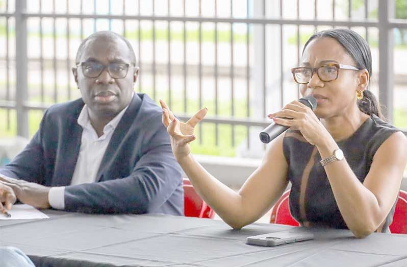 Minister of Tourism, Industry and Commerce, Oneidge Walrond, and Minister within the Office of the Prime Minister, Kwame McCoy speaking to designers and models