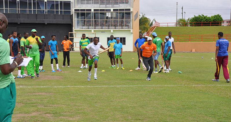 Ok I have the record, let’s go guys! Coach Clive Grimmond (left forefront) keeps the record as Trevon Griffith (left) and Jonathan Foo (right) go through their sprints as the rest of the players including head coach Esuan Crandon look on.
