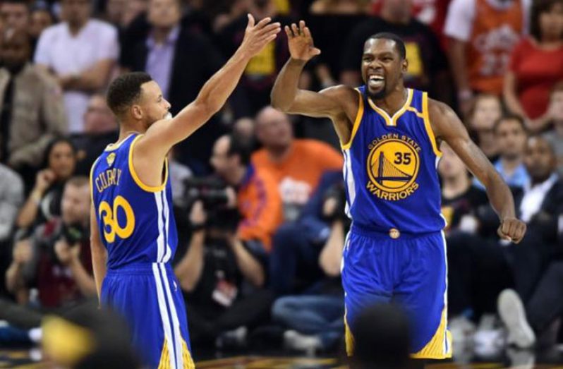 Golden State Warriors guard Stephen Curry (30) and forward Kevin Durant (35) celebrate during the fourth quarter against the Cleveland Cavaliers in game three of the 2017 NBA Finals at Quicken Loans Arena. (Mandatory Credit: Ken Blaze - USA TODAY Sports)