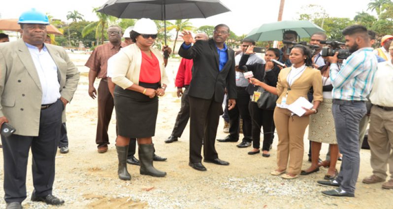 D’urban Pak: Minister of Public Infrastructure David Patterson makes a point to the media yesterday during a site visit at D’urban Park. Also present were Minister within the Ministry of Public Infrastructure Annette Ferguson (left) and Lieutenant Colonel (retd) Larry London