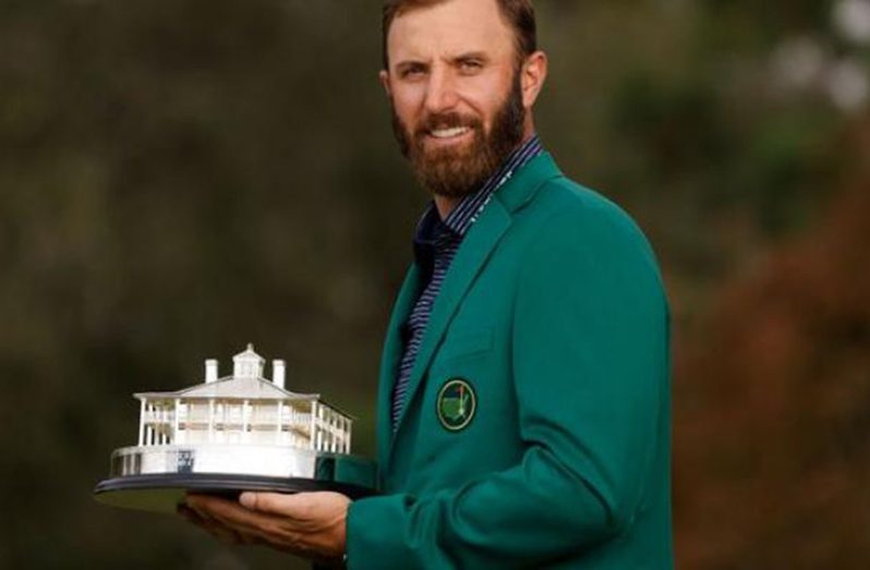 Golf - The Masters - Augusta National Golf Club - Augusta, Georgia, U.S. - November 15, 2020 Dustin Johnson of the U.S. celebrates with his green jacket after winning The Masters REUTERS/Brian Snyder