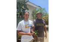 Young apiculturist Davidson Dutchin and his father, David, displaying their own locally produced honey