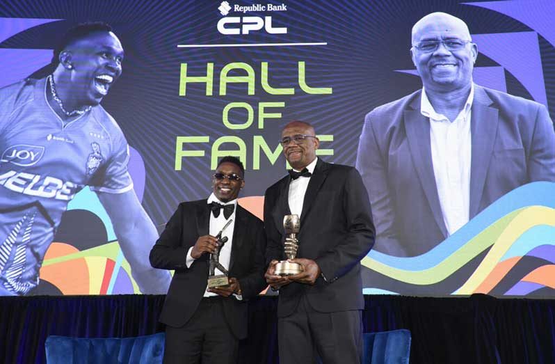 Dwayne Bravo (left) and Ian Bishop pose with their respective awards after being inducted into the CPL Hall of Fame (Photo courtesy CPL)
