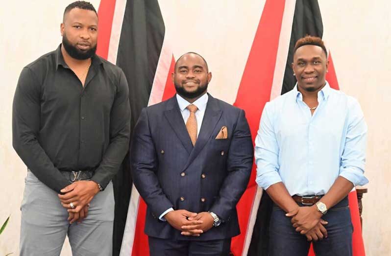 Minister of Foreign and Caricom Affairs Sean Sobers(C) stands alongside newly-appointed sports ambassadors Kieron Pollard (L) and Dwayne Bravo, at the ministry’s headquarters in St Clair, on November 12. – (courtesy Ministry of Foreign and Caricom Affairs).
