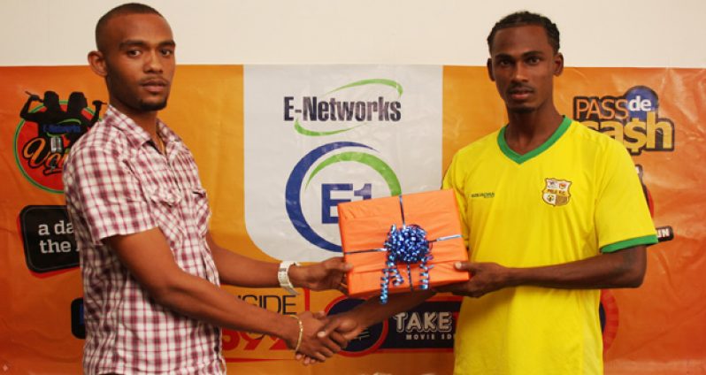E-Networks Marketing Coordinator Joublon Beaton (L) makes a presentation to Gregory ‘Jackie Chan’ Richardson for the E-Networks Goal-of-the-Month.