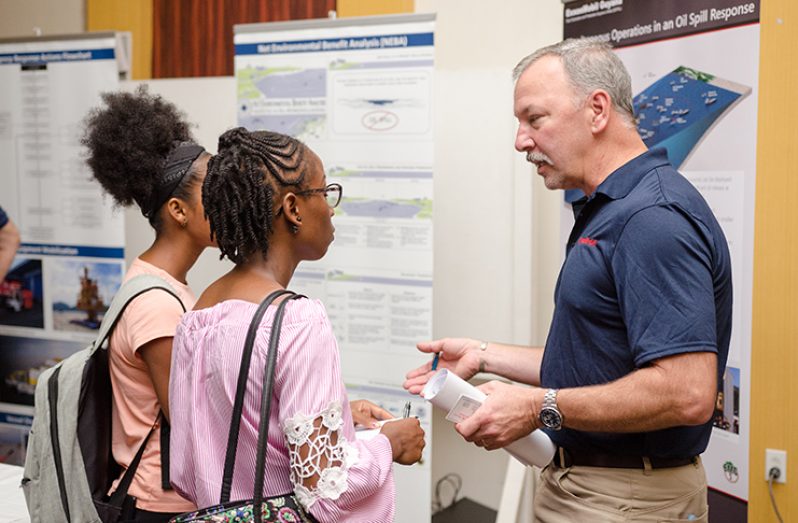 Students from the University of Guyana and members of the public engage experts on the Payara Development Project and its planned operations. (Delano Williams photo)
