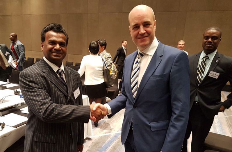 EITI International Board Chairman Fredrik Reinfeldt (right), congratulating Dr Rudy Jadoopat (left) and welcoming Guyana into the EITI family Wednesday October 25, 2017. Curtis Bernard is behind Reinfeldt