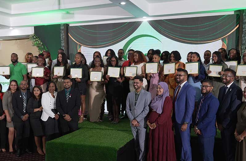 Officials from Recover Guyana, and Scotiabank Guyana, flanked by graduates of ENGAGE 2.0 (Sachin Persaud Photo)