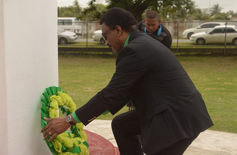 Attorney General and Minister of Legal Affairs Basil Williams pays his respects at the Enmore Martyrs Monument to the five sugar workers who lost their lives in 1948 in the fight for better wages and working conditions. (Adrian Narine photo)