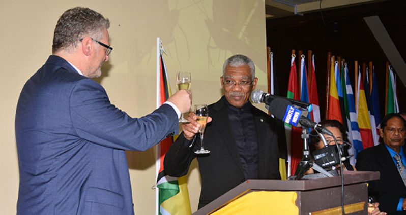 President David Granger shares a toast with EU Ambassador Jernej Videtic on Monday night in observance of Europe Day 2016 (Samuel Maughn photo)