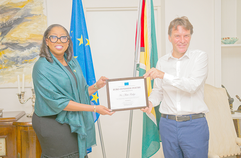 Dr. Alista Bishop receives her award from EU Ambassador to Guyana Lucas Pierantoni (Delano Williams photo)
