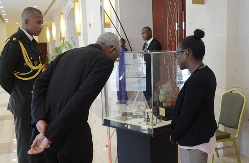 President David Granger viewing the exhibits on display on the sideline of the Heads of Government Meeting in Montego Bay, Jamaica in the presence of Kerry Ann Watson – a curator attached to the National Museums West.