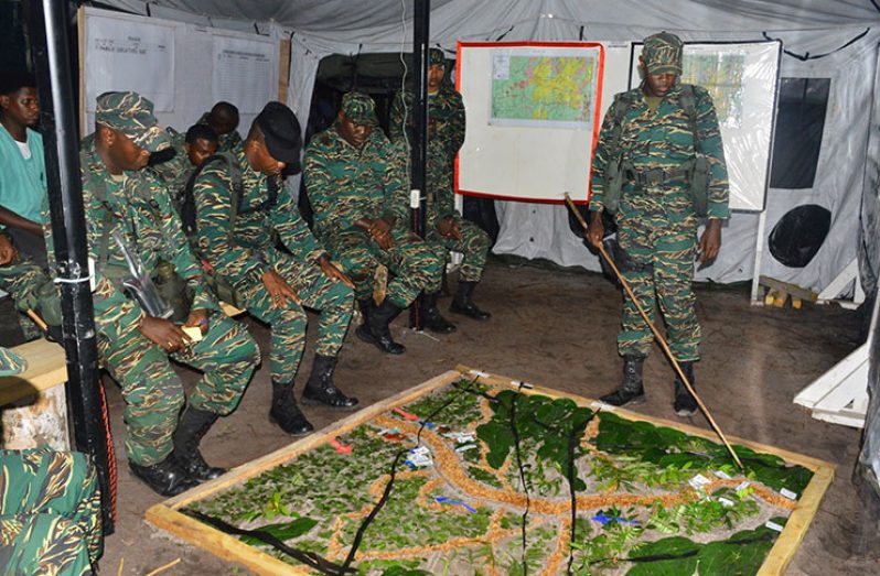 Soldiers being told of the schematics of the exercise course