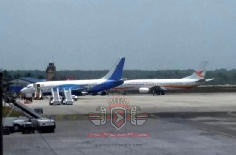 Easy Sky’s Boeing 732 aircraft (blue tail) on the ground at the CJIA on Tuesday. The aircraft departed by midday.