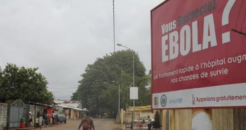 A billboard with a message about Ebola is seen on a street in Conakry, Guinea in this October 26, 2014 file photo.