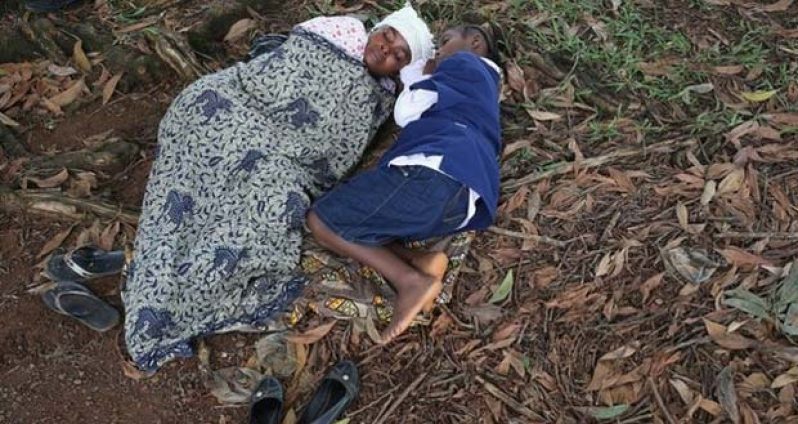 (BBC News photo) Liberia has been badly affected by the outbreak - here a mother and daughter lie near a treatment centre